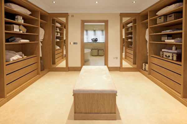 a large and luxurious walk-in wardrobe situated between the main bedroom and bathroom in an expensive new home.  Furnished and decorated by a leading Interior Designer whilst preparing this house as a show-home.